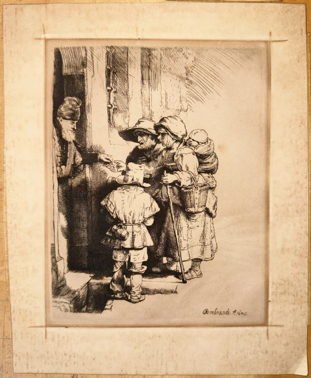 REMBRANDT VAN RIJN (1648) ETCHING TITLED BEGGARS RECEIVING ALMS AT DOOR OF A HOUSE, 15IN x 17IN (38cm x 43cm)
